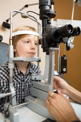 Boy Having His Eyes Examined With Slit Lamp By Doctor
