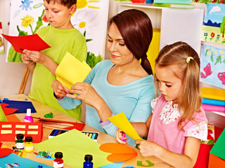 Children with teacher at classroom.