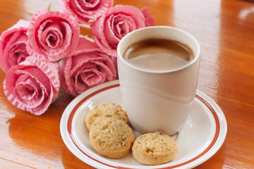 Drink hot coffee, eat cookie in cold day.