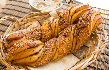 Breakfast still life with twisted bread with garlic and sesame s