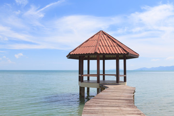 Wooden pier with pavilion in the sea