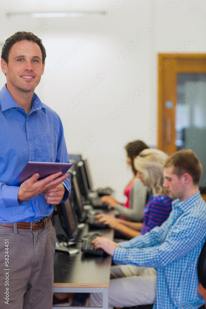 Poster Teacher with students using computers in computer room