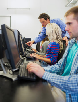 Teacher Showing Something On Screen To Student In Computer Room