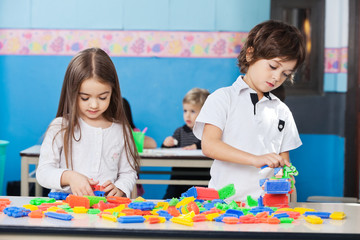 Children Playing With Construction Blocks