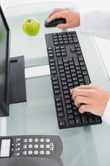 Hands using computer at medical office