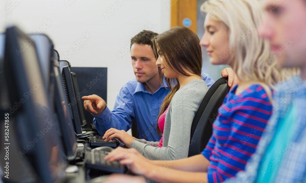 Poster teacher showing something on screen to student in computer room