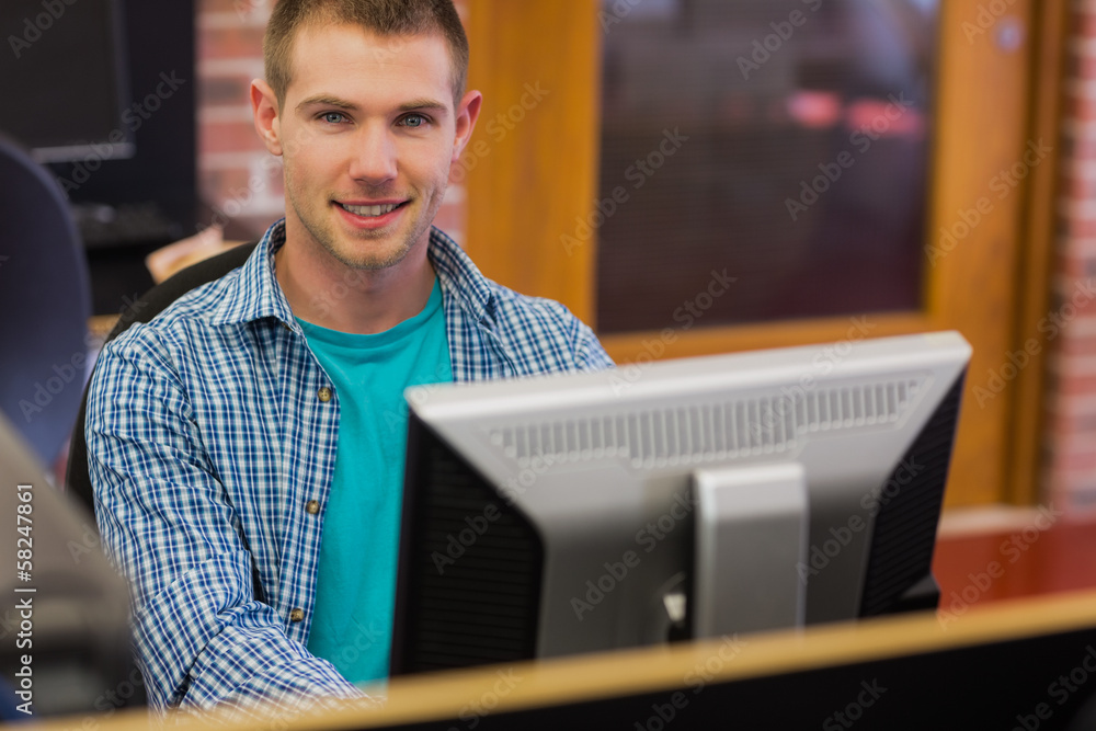 Poster male student using computer in the computer room