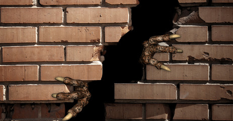 Paws of monster , breaking a brick wall