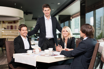 Business team having meeting at the restaurant.