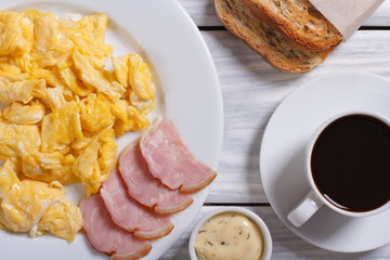 Breakfast view from above. Omelet with ham and tomatoes. coffee