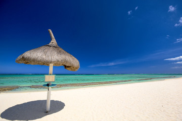 Tropical beach with umbrella in Mauritius