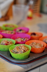 Cooking muffins in colourful plastic cups