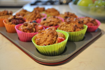 Cooking muffins in colourful plastic cups