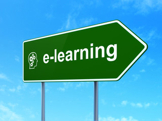 Education concept: E-learning and Head With Gears on road sign