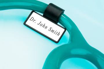 Stethoscope with ID tag on blue background