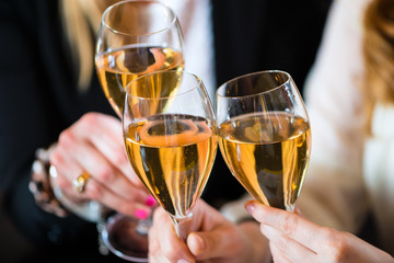 Teamwork - clinking the glasses with champagne