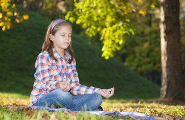 Girl meditating in the park