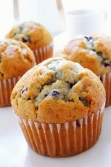 Blueberry muffins with coffee cup and maker