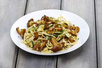 Macaroni with mushrooms on wooden rustic table. Autumn setting
