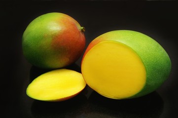 mangos isolated on black background