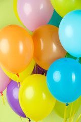 Colorful balloons on green background