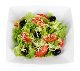 Light salad on plate isolated on white