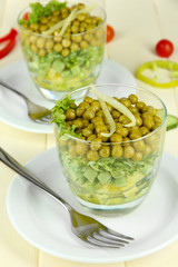 Tasty salad with fresh vegetables on wooden table