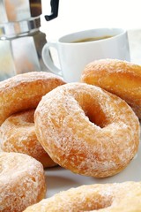 Sugared donuts with coffee
