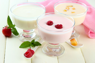 Delicious yogurt with fruit and berries on table close-up