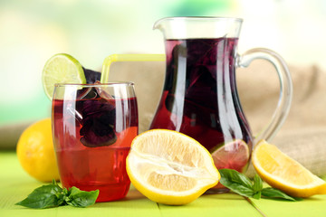 Red basil lemonade in jug and glass,