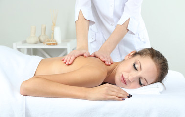Obraz na płótnie Canvas Beautiful young woman having back massage close up