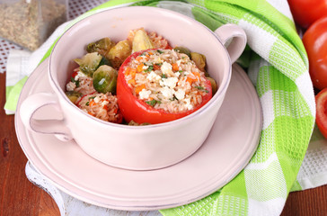Stuffed tomatoes in pan on wooden table close-up