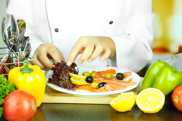 Cook hands decorating dish