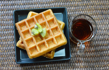 A cup of tea and waffles on the table