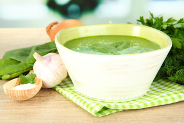 Tasty spinach soup, on wooden table