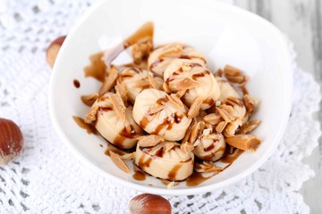 Many toffee in bowl on napkin close-up