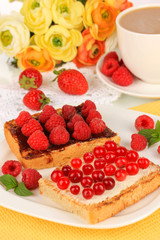 Delicious toast with berries on table close-up