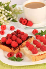 Delicious toast with raspberries on table close-up