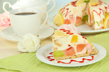 Delicious jelly cake on table on light background
