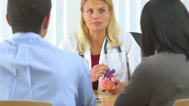 Doctor explaining heart condition to couple