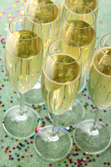 Glasses with champagne on shiny background
