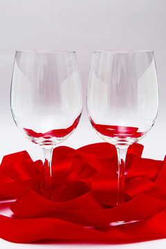 Empty wineglasses with red ribbon