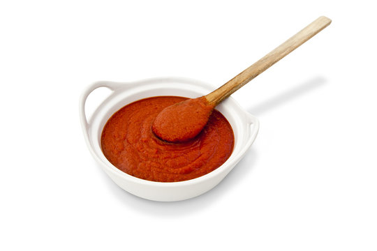 Tomato sauce and wooden spoon