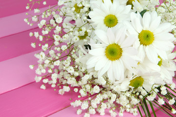 Obraz premium Beautiful flowers on wooden background
