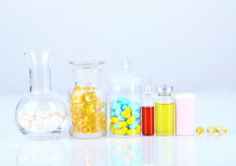 Medical bottles and pills isolated on white
