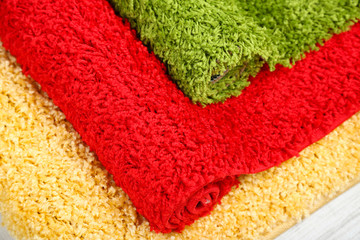 Many carpets of different colors close-up