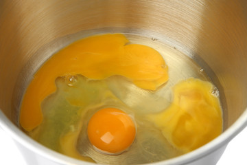 Cooking, whipping eggs with electric whisk in bowl, close up