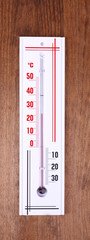 Thermometer on wooden background