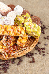 Tasty oriental sweets, on burlap background