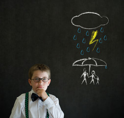 Boy thinking about protecting family on blackboard background